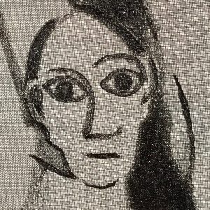 Close-up photo of aluminum screen art of woman's face