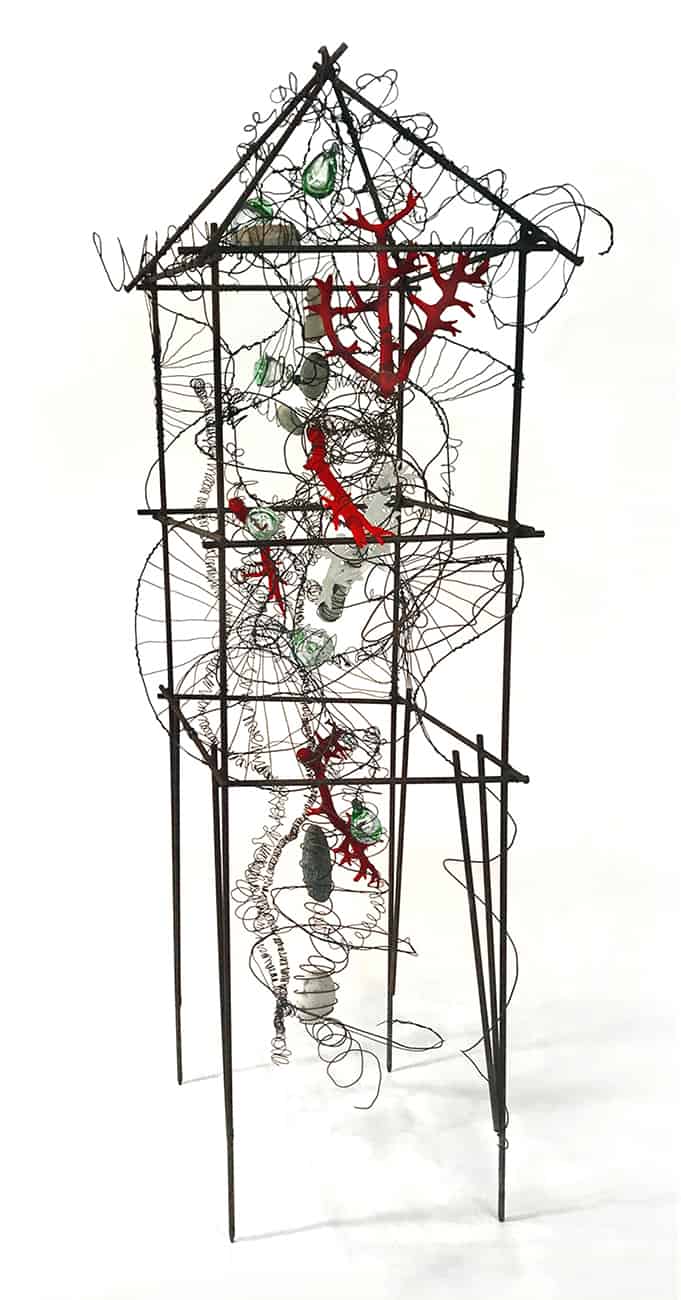 Standing house-shaped sculpture created with wire and mixed media