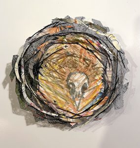 Nest shaped mixed-media construction of cut watercolor painted paper image of bird skull.